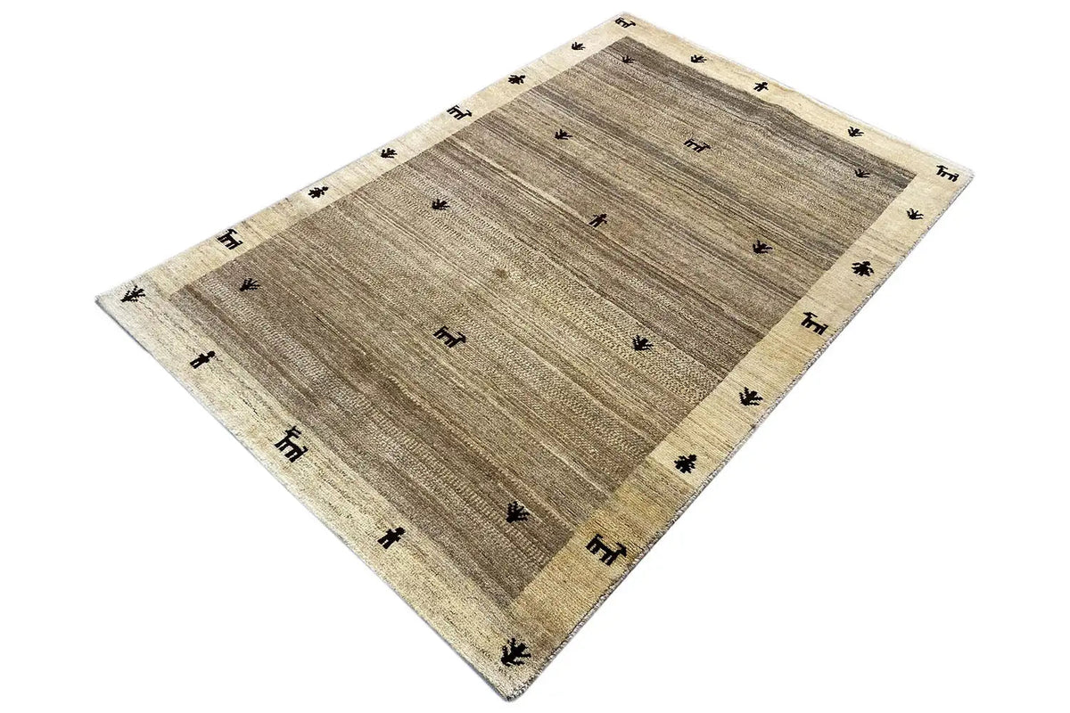 Gabbeh rug 181x116 cm, beige rug with dark tribal symbols in the field.