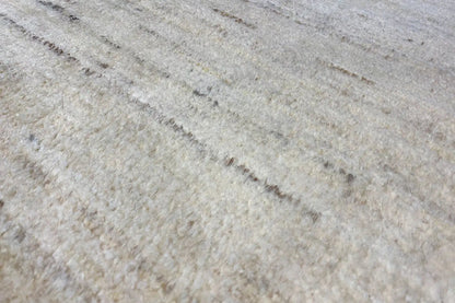 Gabbeh rug 174x110 cm, close-up: light beige surface with fine, irregular lines