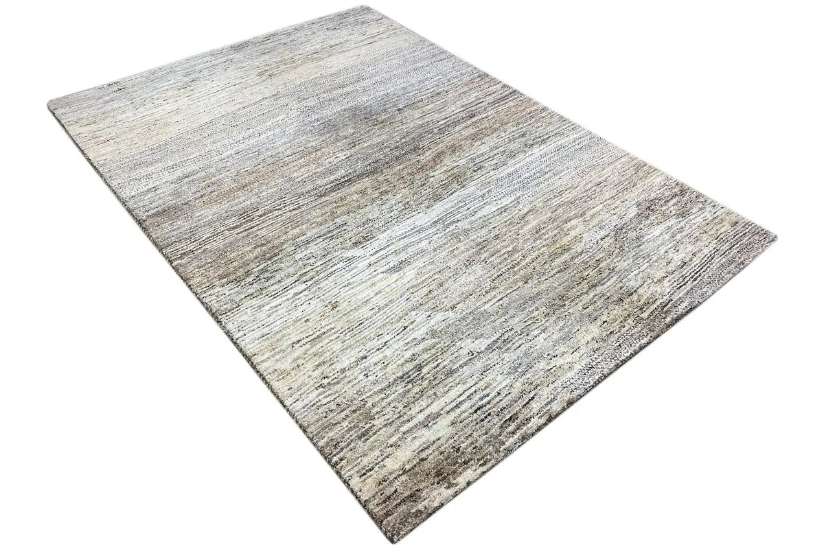 Gabbeh rug laid flat, light beige surface with gray and brown lines