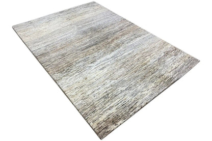 Gabbeh rug laid flat, light beige surface with gray and brown lines