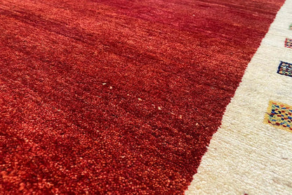 Red carpet section with a fine texture and a beige border featuring ornaments