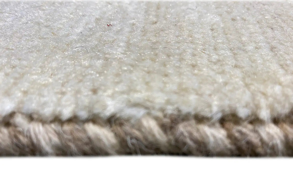 Close-up: beige Gabbeh rug with a fine pile and mottled weave texture