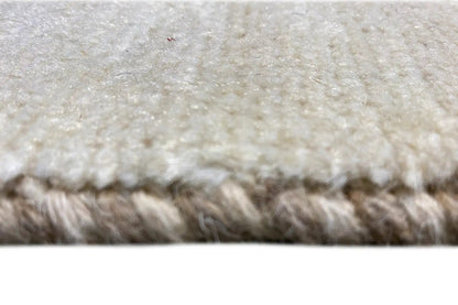 Close-up: beige Gabbeh rug with a fine pile and mottled weave texture