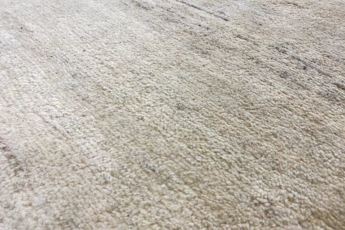 Gabbeh rug, fine pile texture in light beige with a subtle gray tone