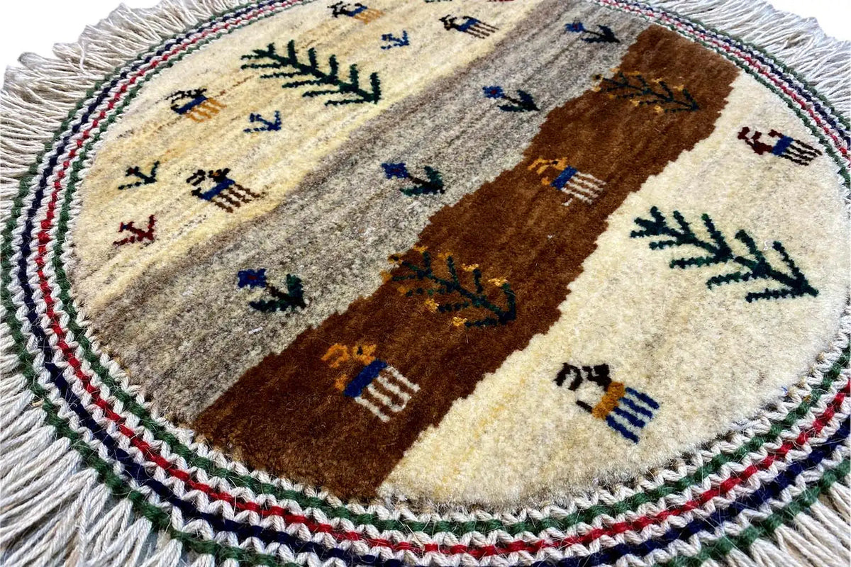 Close-up of a round Gabbeh-Lori cushion, 40x40 cm, with a woven tree and figures pattern