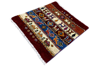 Gabbeh Lori rug, diagonal view, burgundy, blue and cream with figurative patterns, fringes