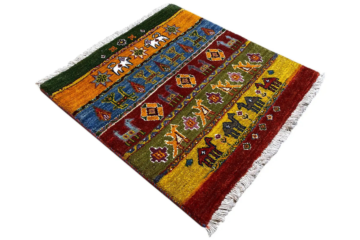 Gabbeh rug with colorful row ornaments, photographed diagonally, with fringes