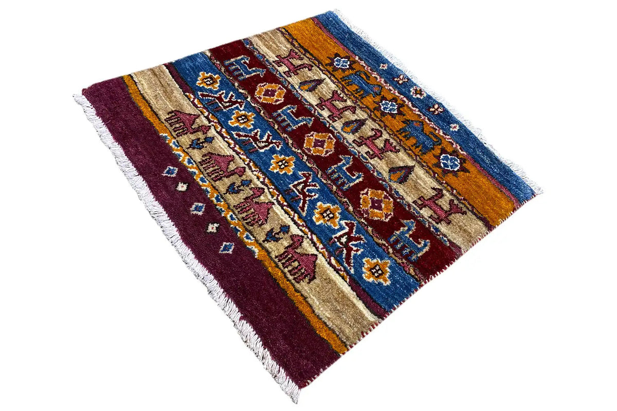 Gabbeh Lori rug placed at an angle with striped pattern, blue, beige, burgundy, fringes