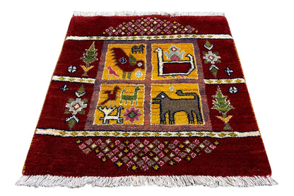 Gabbeh Lori rug with a red background, multicolored medallions, and a white fringed border