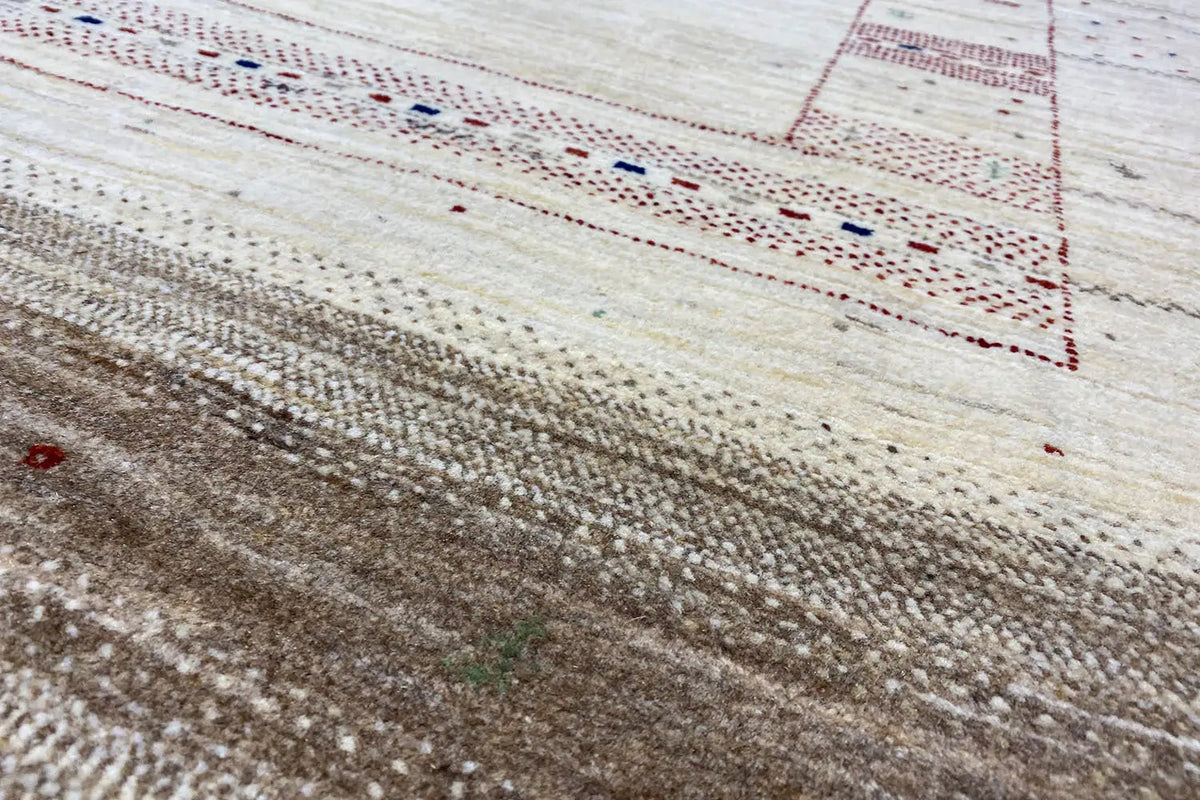 Details of Lori Gabbeh rug: dense pile with brown areas and red/blue accents