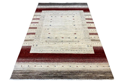 Gabbeh rug laid flat: cream, reddish-brown, and gray stripes in the layout
