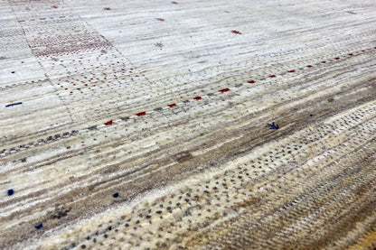 Gabbeh rug detail: beige background with stripes and colorful speckles