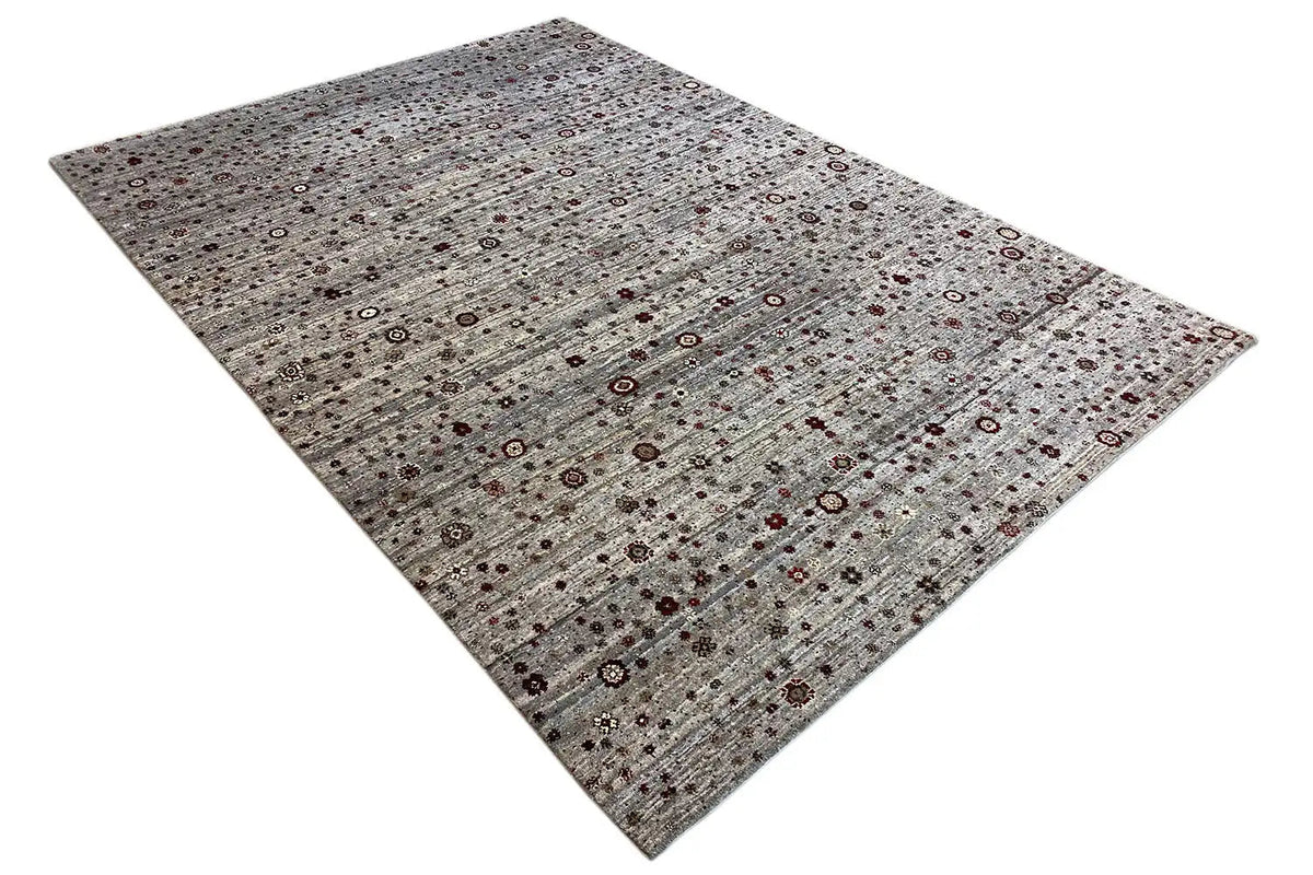 Gabbeh Lori rug in gray-brown with an ornamental mosaic, viewed from an oblique perspective