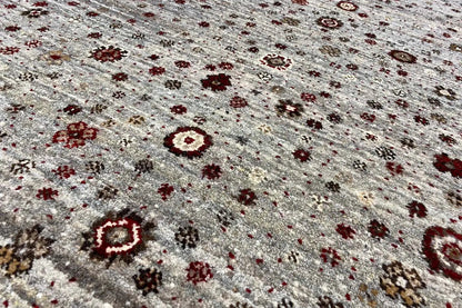 Close-up of a Gabbeh Lori rug: gray-brown pile with brown and dark red ornaments