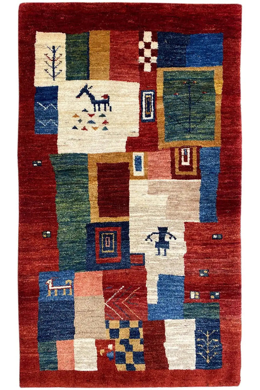 Rug with a red background and block patterns in blue, green, and cream, centered