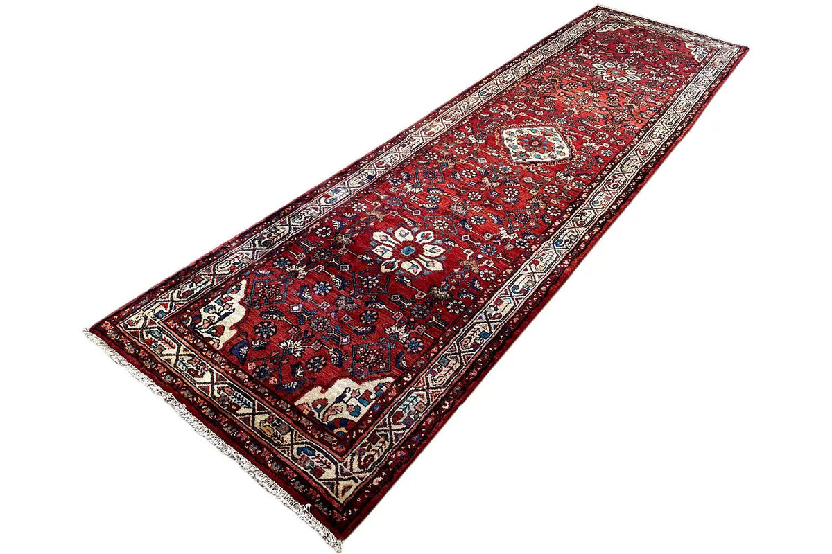 Hamadan runner laid at an angle: red pattern with border and central ornaments