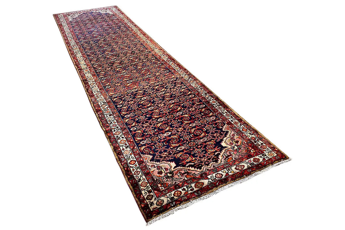 Oriental runner rug spread diagonally, dark blue background with red, beige, and patterned border.