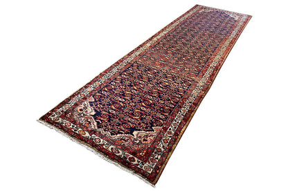 Oriental rug runner, diagonal, dark blue-red pattern with a beige border band and uniform edging.