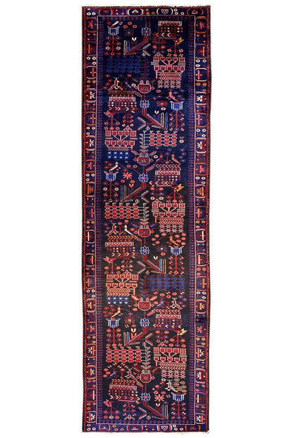 Narrow runner rug with a dark background and red, blue, and cream-colored ornaments