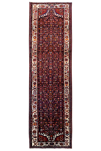 Narrow dark red oriental rug runner with a light decorative border and central motif