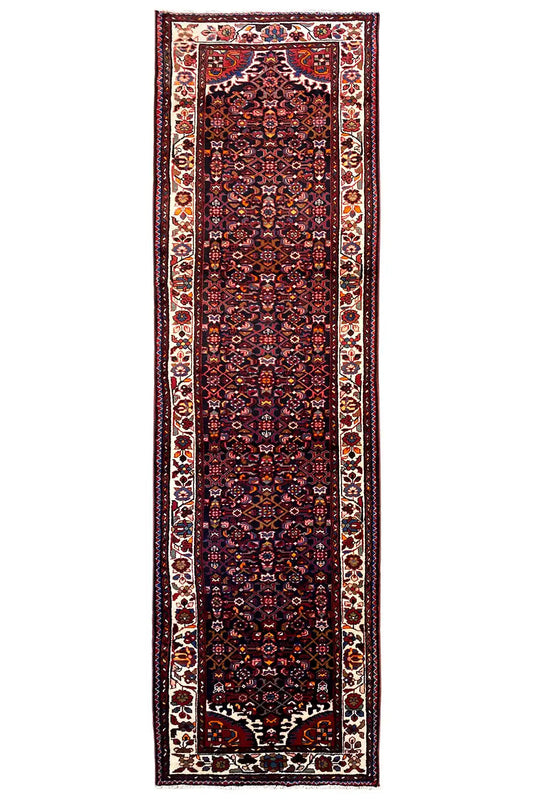 Narrow dark red oriental rug runner with a light decorative border and central motif