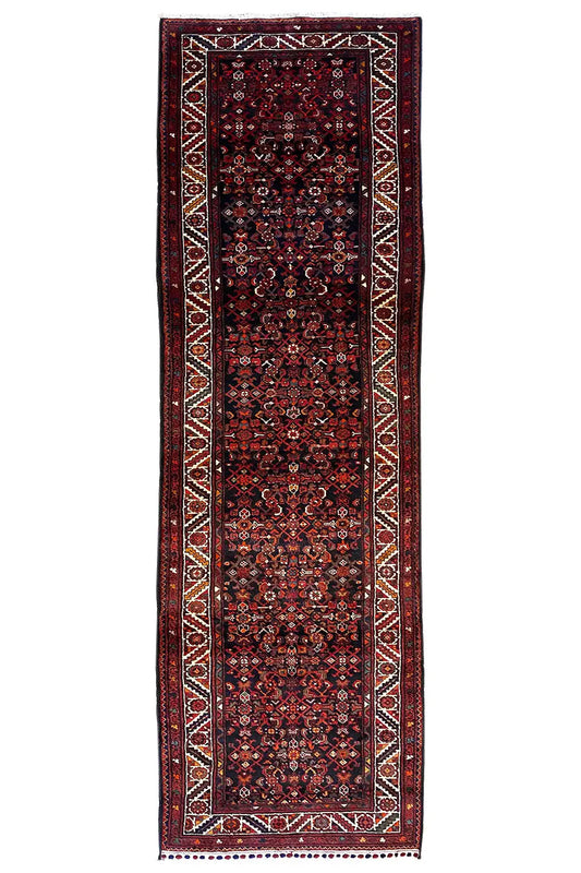 Rectangular oriental rug runner with a dark red pattern and decorative border along the edges