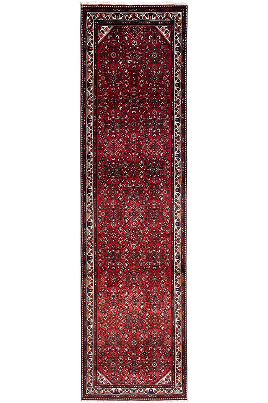 Narrow red runner with a framed border, central ornamental panel, and outlined corners