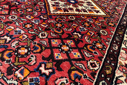 Hamadan runner close-up: colorful Oriental pattern in red, blue, and cream