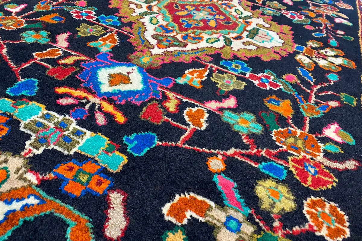 Close-up of the carpet pile: colorful geometric patterns on a dark background