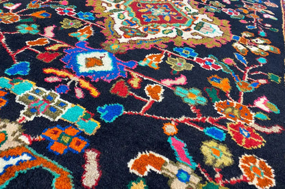 Close-up of the carpet pile: colorful geometric patterns on a dark background