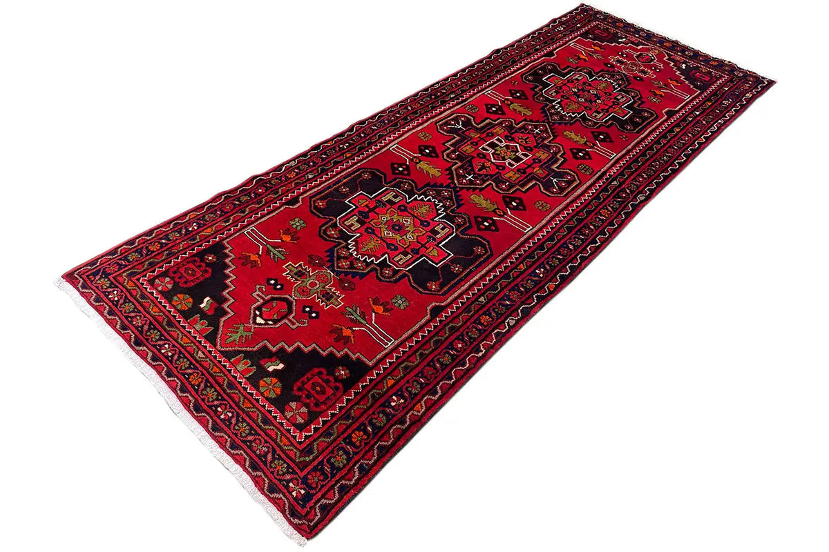 Hamadan runner with a red ground, finely patterned border, and clear diagonal ornaments