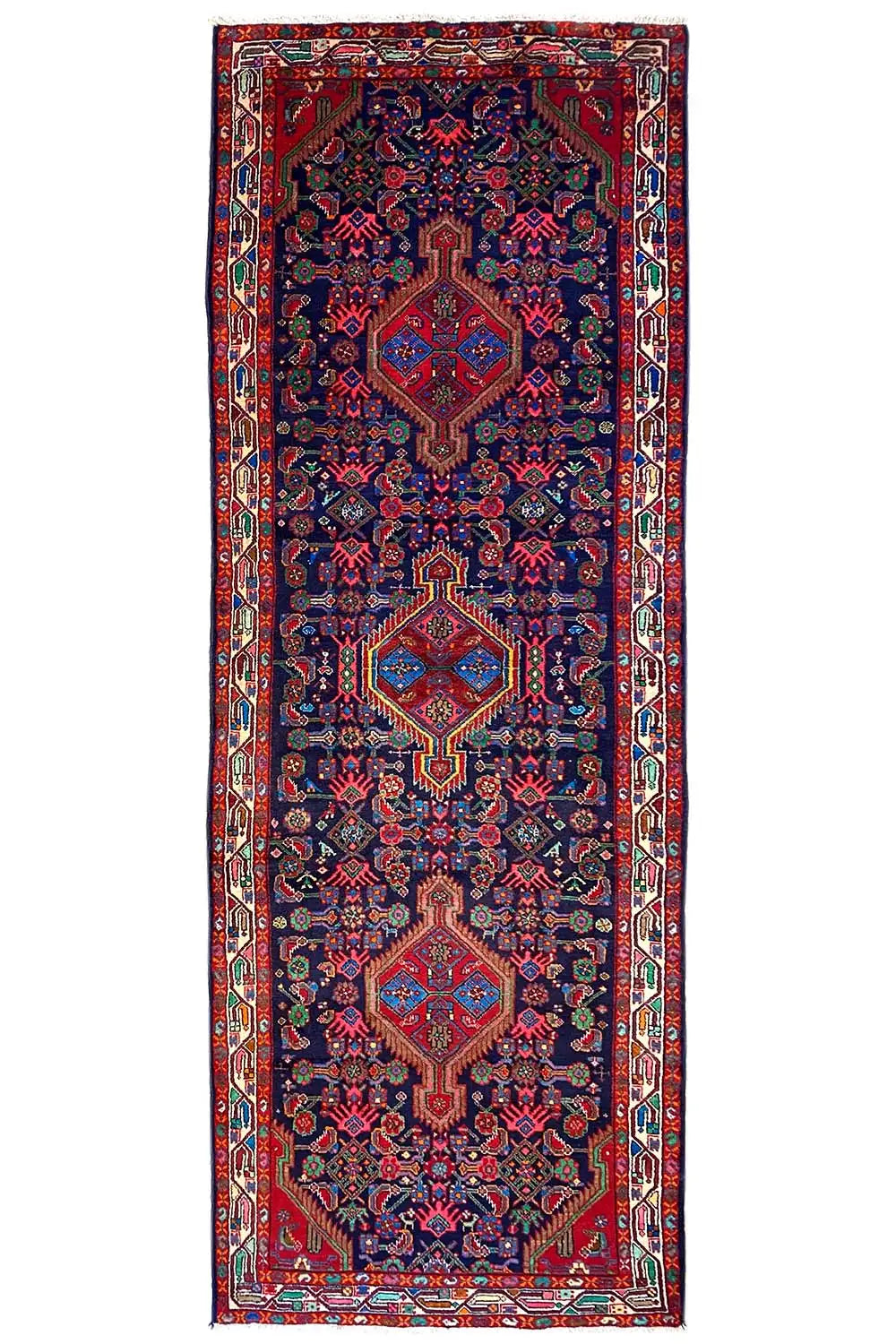 Rectangular oriental runner rug with border and all-over ornaments in blue and red