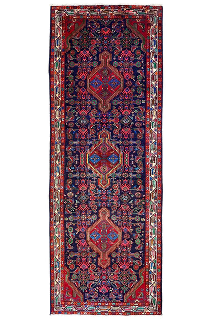 Rectangular oriental runner rug with border and all-over ornaments in blue and red