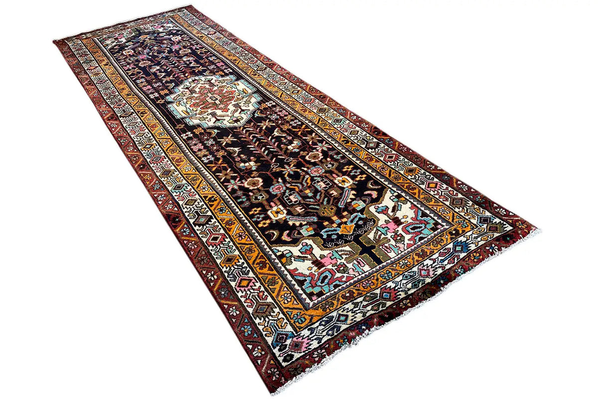 Oriental rug runner laid diagonally, geometric pattern with colored border stripes