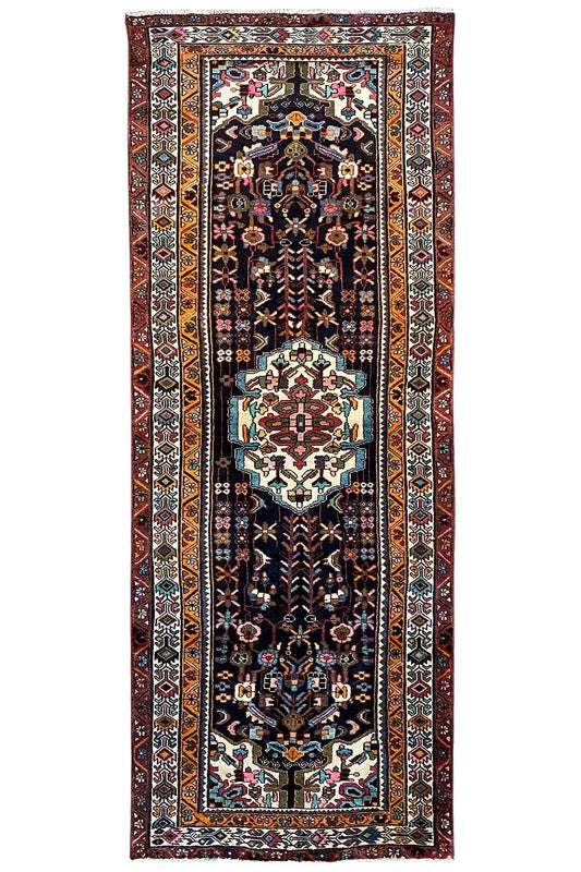 Rectangular Oriental rug runner with a dark background, a central medallion, and borders