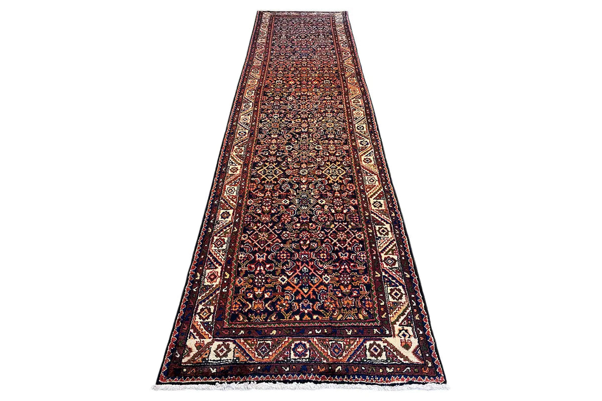 Long, narrow runner: bold ornamental pattern with a multicolored border on a dark background