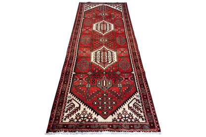 Hamadan runner with a red Oriental rug pattern, central medallion, diagonal view
