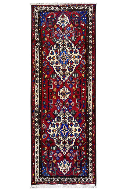 Hamadan runner in the image: red rectangular design with a blue-and-white decorative pattern and fringes