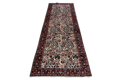 Runner rug with a narrow dark border and a vibrant pattern in shades of red, beige, and blue