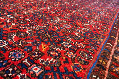 Close-up: detailed red and blue ornamental pattern on a runner rug