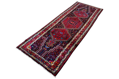 Hamadan runner laid flat, central medallions in red and dark blue