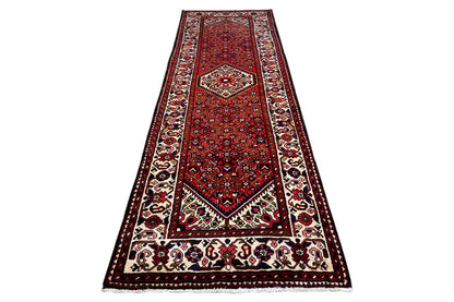 Red carpet runner with central medallion, wide border, and fringe