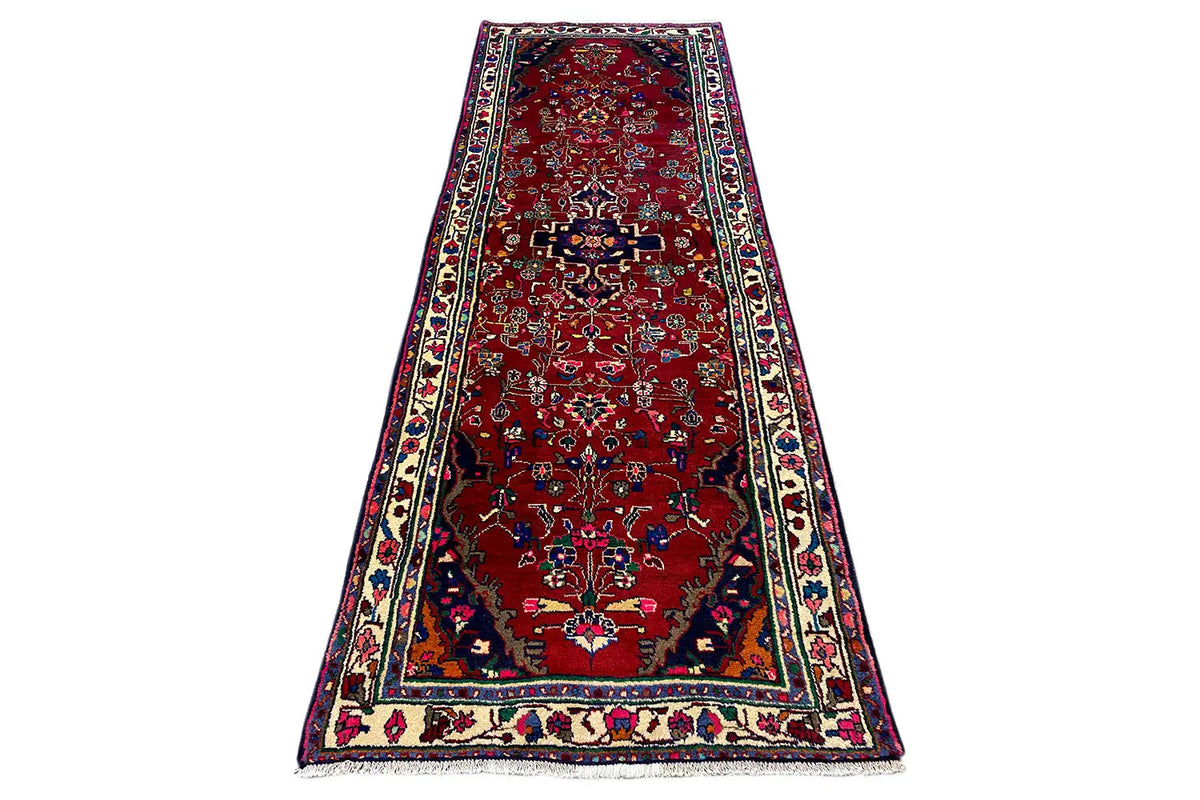 Hamadan runner on a stand, red with an ornamental carpet pattern and a wide multicolored border