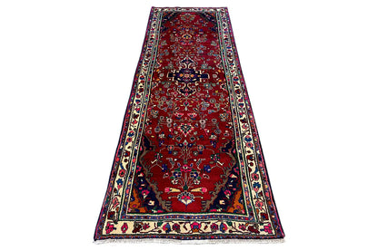 Hamadan runner on a stand, red with an ornamental carpet pattern and a wide multicolored border