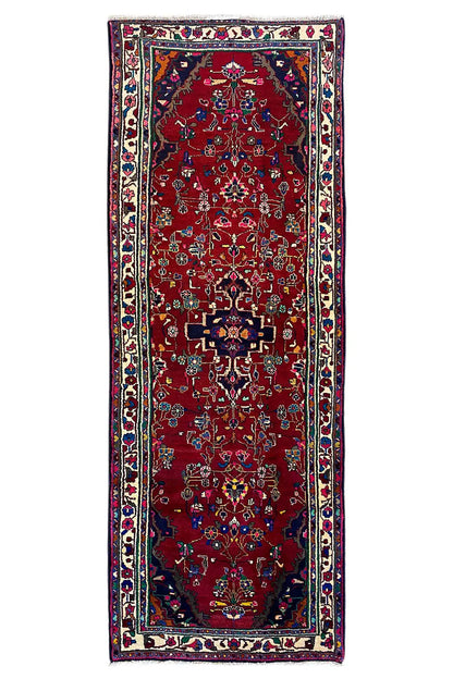 Hamadan runner, frontal view, red field with central medallion, multicolored border