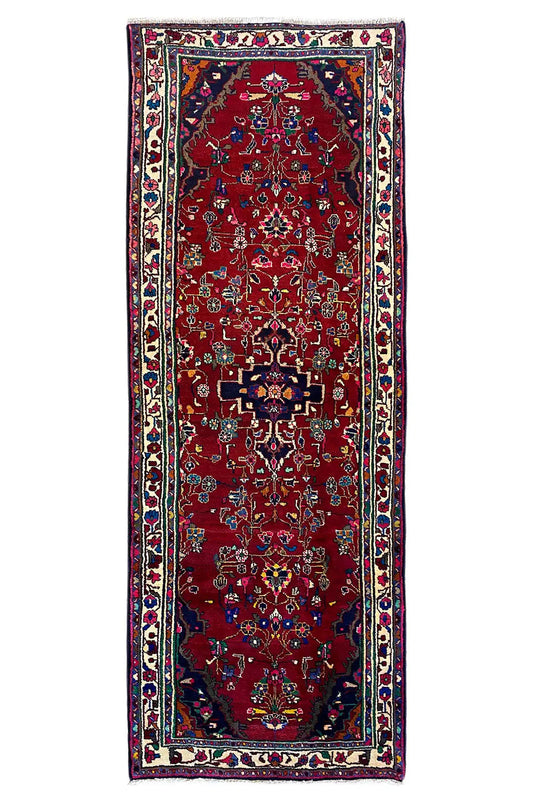 Hamadan runner, frontal view, red field with central medallion, multicolored border
