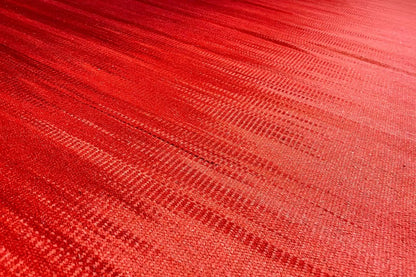 Red kilim rug with a fine linear texture and dense pile