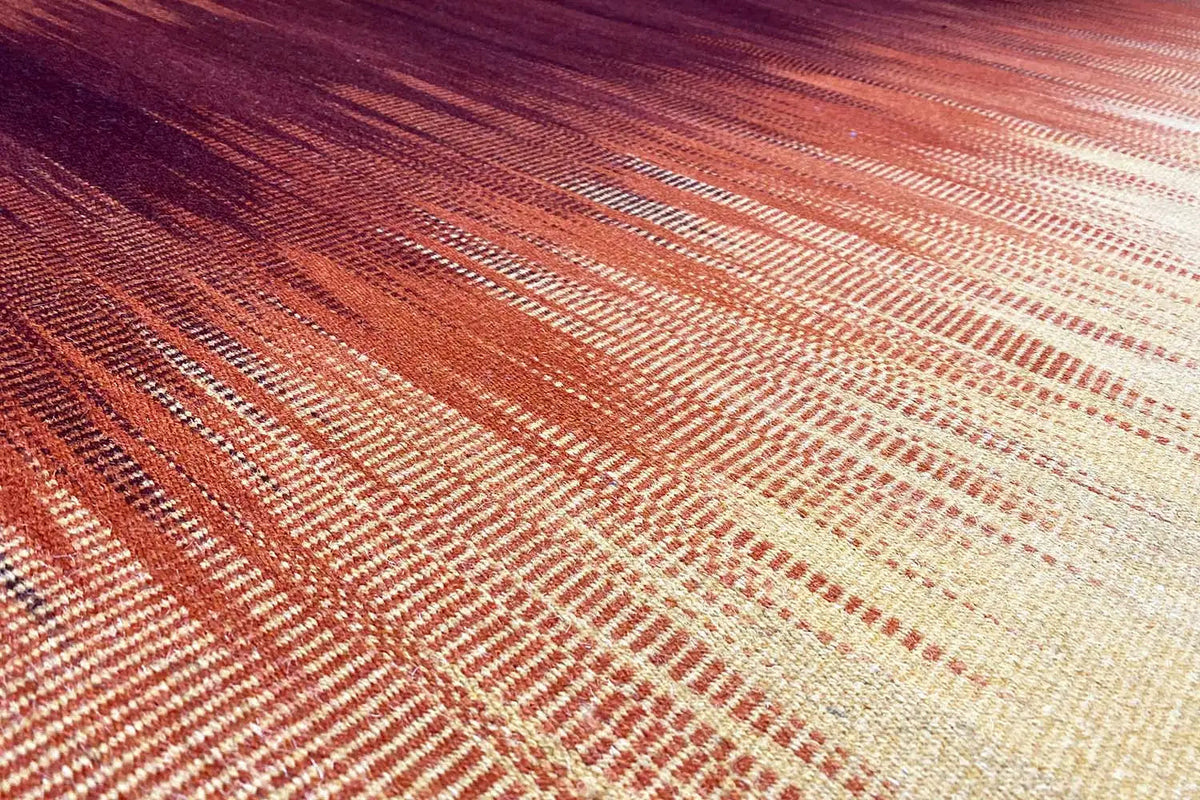 Kilim rug in yellow with an orange woven pattern, close-up of the surface