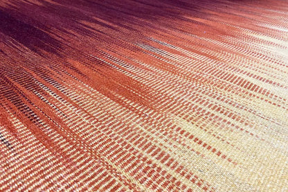 Kilim rug in yellow with an orange woven pattern, close-up of the surface