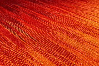 Kilim dhurrie rug, orange-red woven texture with fine diagonal stripes